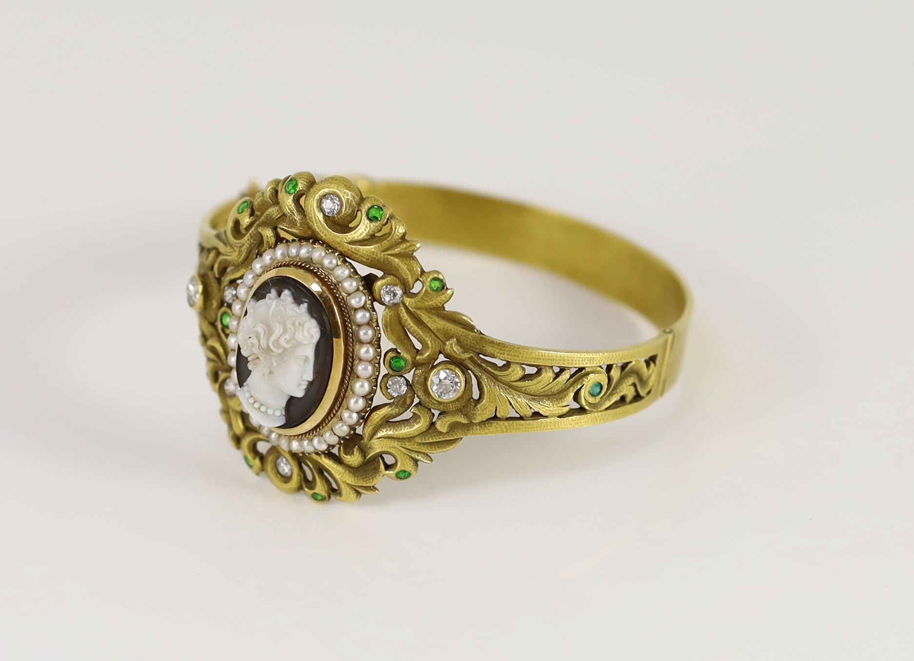 A Victorian gold, sardonyx cameo, split pearl, diamond and demantoid garnet set hinged bangle